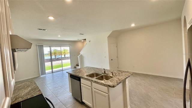 kitchen with a kitchen island with sink, stone countertops, sink, stainless steel dishwasher, and white cabinetry