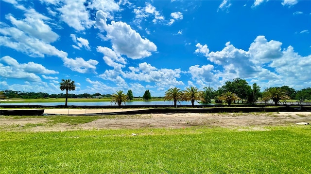 view of community featuring a water view and a yard