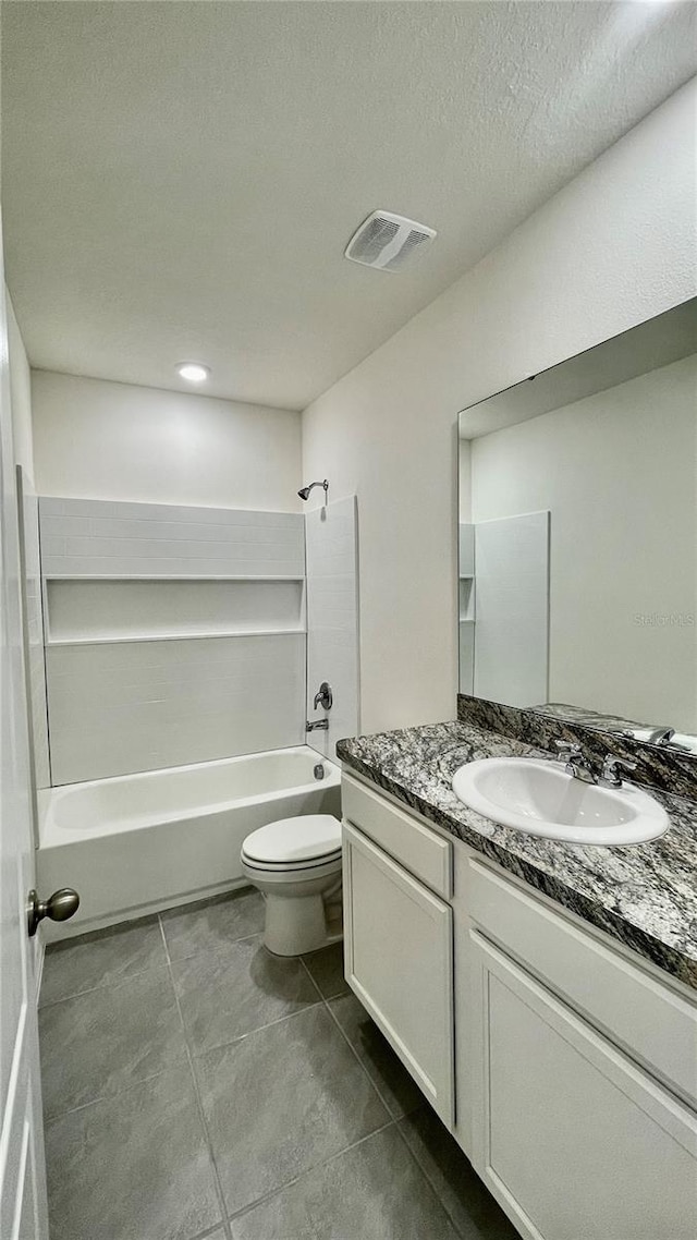 full bathroom featuring vanity, toilet, a textured ceiling,  shower combination, and tile patterned flooring