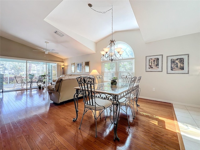 dining space with lofted ceiling, hardwood / wood-style floors, and ceiling fan with notable chandelier