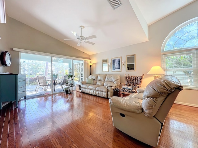 living room featuring lofted ceiling, hardwood / wood-style flooring, and ceiling fan