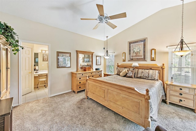 carpeted bedroom with ensuite bath, ceiling fan, and vaulted ceiling