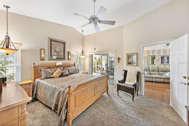 carpeted bedroom with vaulted ceiling, access to exterior, and ceiling fan