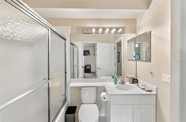 full bathroom with vanity, bath / shower combo with glass door, and toilet