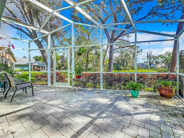 view of patio / terrace featuring glass enclosure