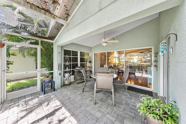 sunroom / solarium featuring ceiling fan and vaulted ceiling