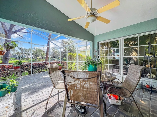 sunroom with lofted ceiling and ceiling fan