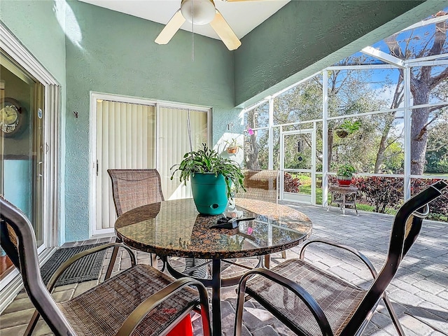 sunroom featuring ceiling fan