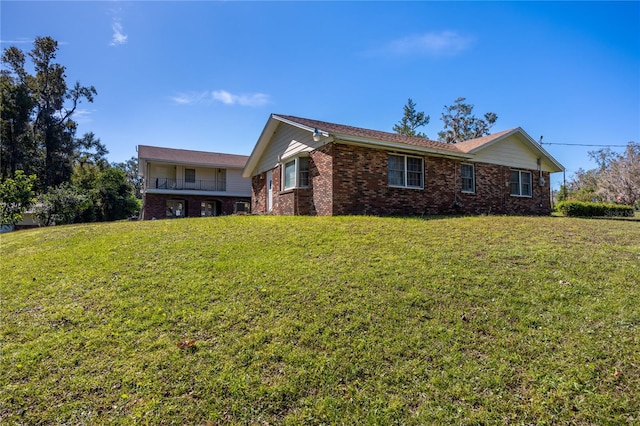 view of property exterior with a balcony and a lawn