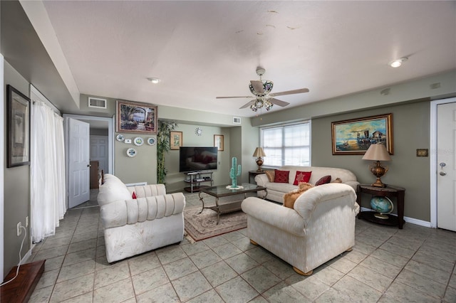 tiled living room featuring ceiling fan