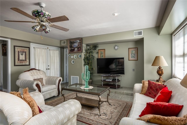 tiled living room with ceiling fan