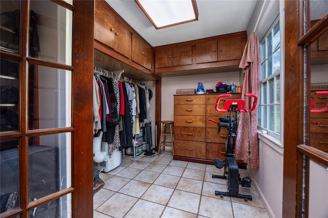 spacious closet featuring light tile patterned flooring