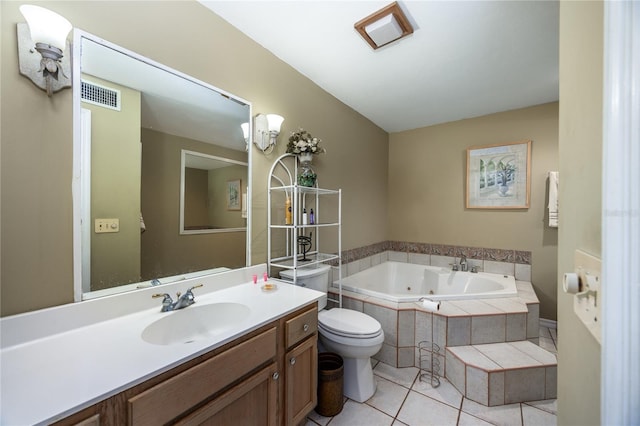 bathroom featuring vanity, toilet, tiled tub, and tile patterned floors