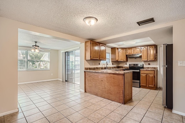 kitchen featuring appliances with stainless steel finishes, a textured ceiling, and ceiling fan