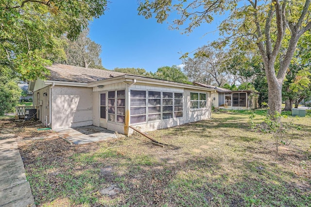 rear view of property featuring a sunroom