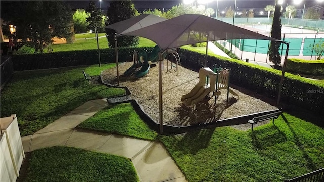 view of home's community with a playground, a yard, and a swimming pool