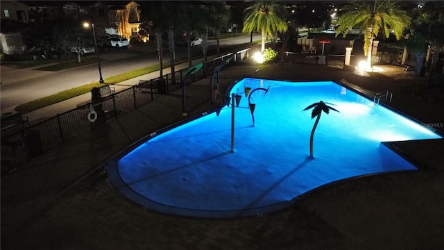 pool at night with a patio