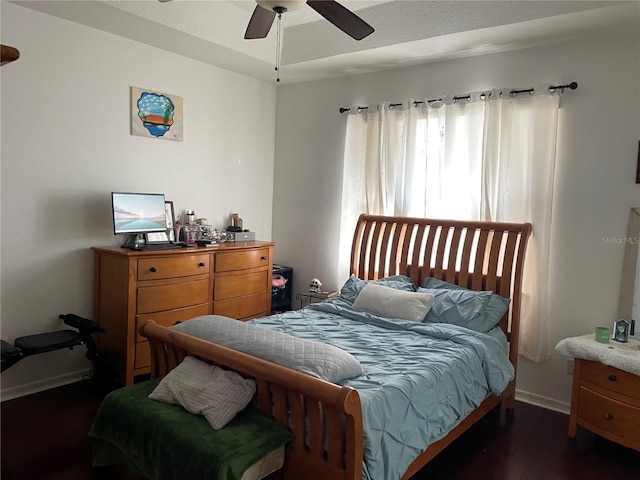 bedroom with dark hardwood / wood-style floors and ceiling fan