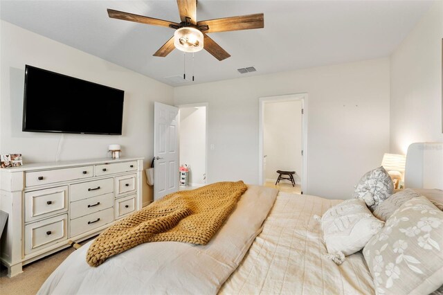 bedroom featuring light carpet and ceiling fan