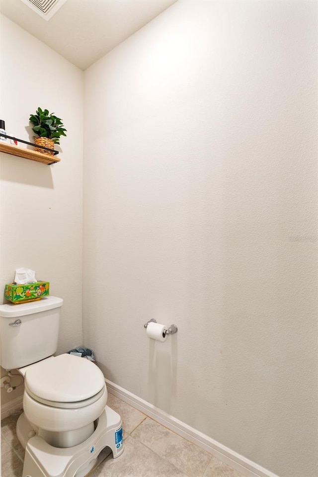 bathroom with toilet and tile patterned flooring