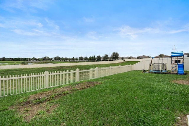 view of yard with a rural view and a trampoline