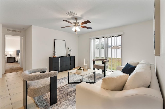 living room featuring ceiling fan and light tile patterned floors