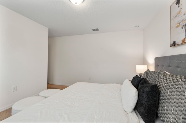 carpeted bedroom featuring a textured ceiling