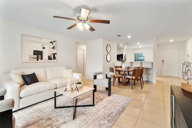 living room featuring ceiling fan and light tile patterned flooring