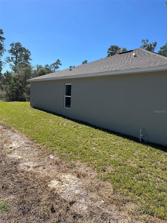 view of property exterior with a yard