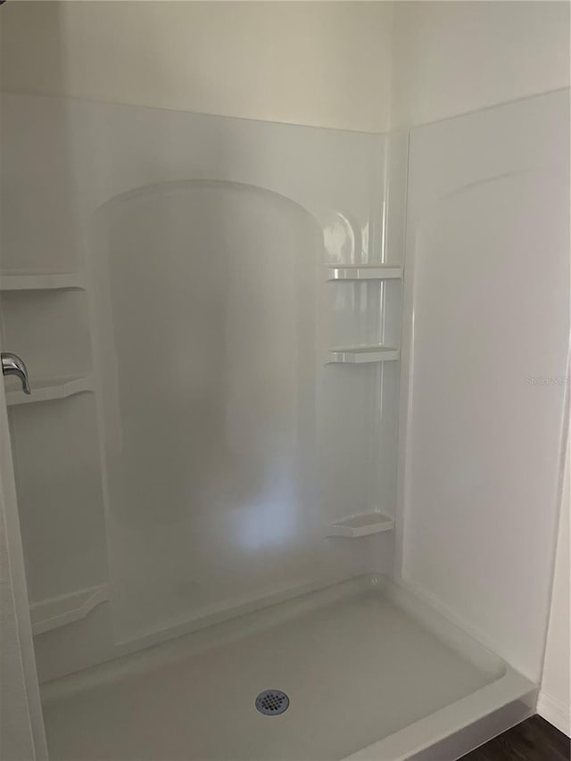 bathroom featuring hardwood / wood-style floors and a shower