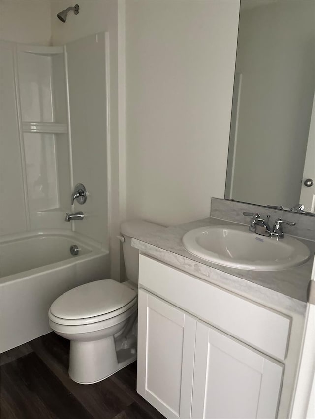 full bathroom featuring bathtub / shower combination, vanity, wood-type flooring, and toilet