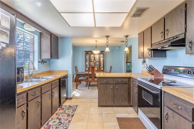 kitchen featuring sink, black dishwasher, decorative light fixtures, electric stove, and light tile patterned floors