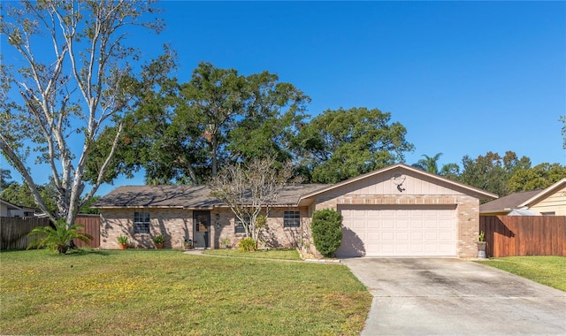 ranch-style home featuring a front lawn and a garage