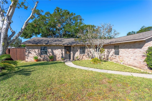 single story home featuring a front yard