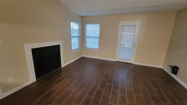 unfurnished living room with dark hardwood / wood-style floors