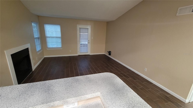 unfurnished living room featuring dark hardwood / wood-style floors