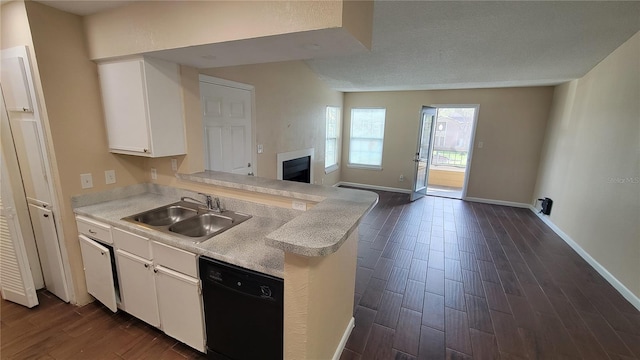 kitchen with sink, dishwasher, kitchen peninsula, white cabinets, and dark wood-type flooring