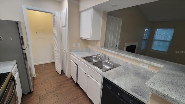 kitchen with kitchen peninsula, white cabinetry, wood-type flooring, black appliances, and sink