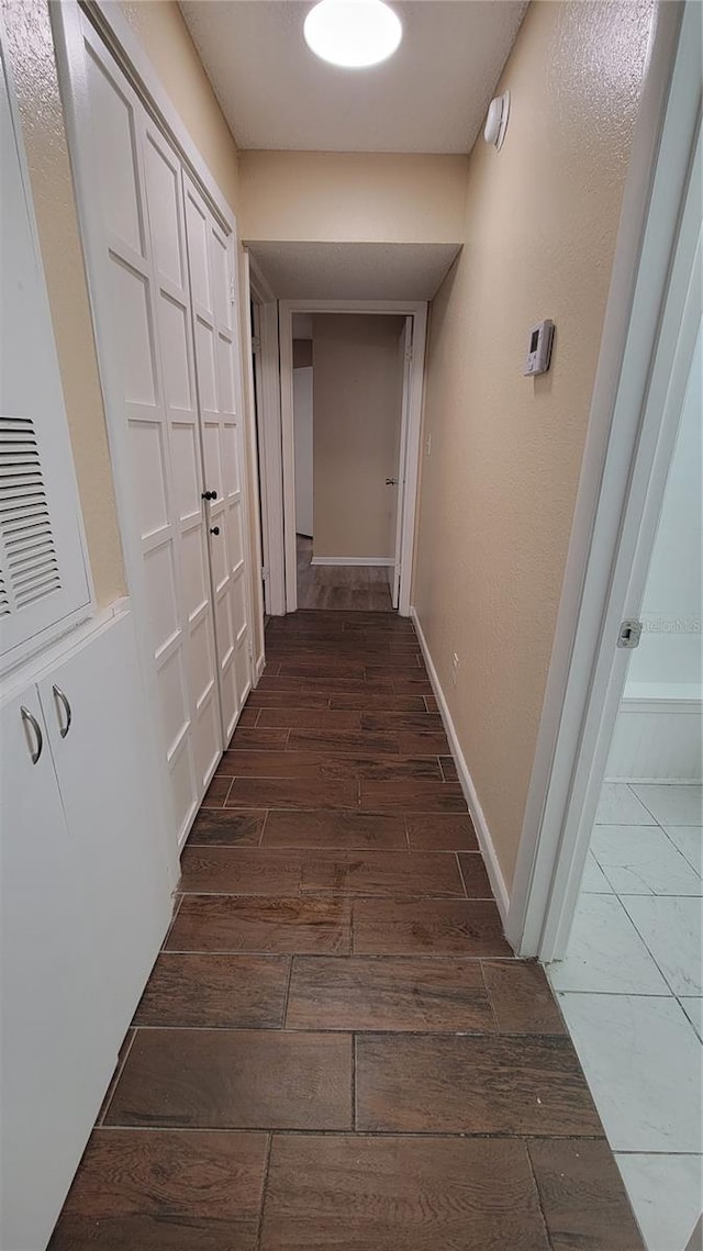 corridor with dark wood-type flooring