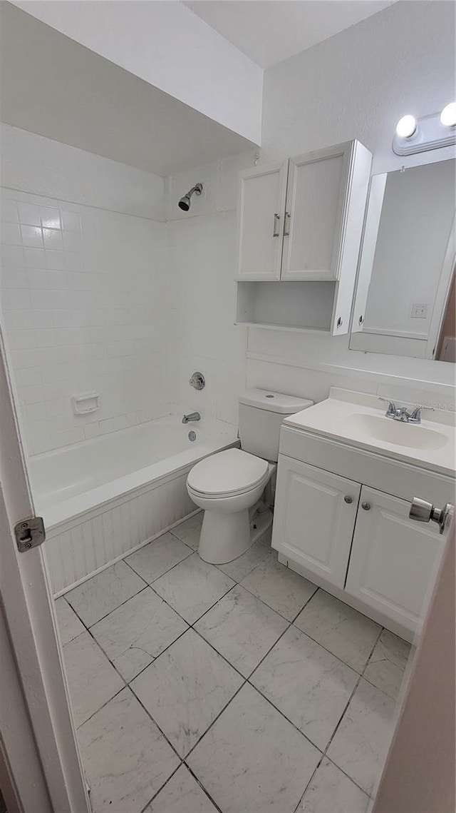 full bathroom featuring shower / washtub combination, marble finish floor, vanity, and toilet
