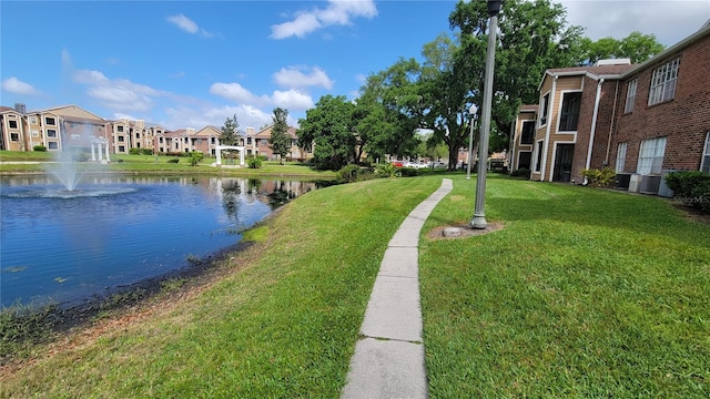 view of community with a yard and a water view