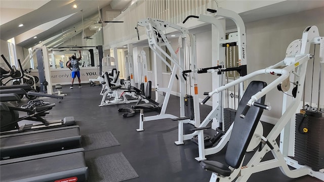 workout area featuring lofted ceiling and ceiling fan