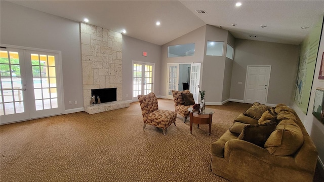 living room with french doors, a healthy amount of sunlight, high vaulted ceiling, and carpet flooring