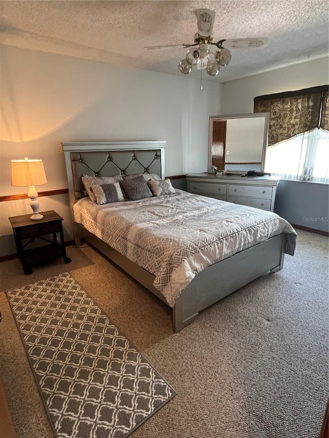 bedroom featuring a textured ceiling, carpet flooring, and ceiling fan