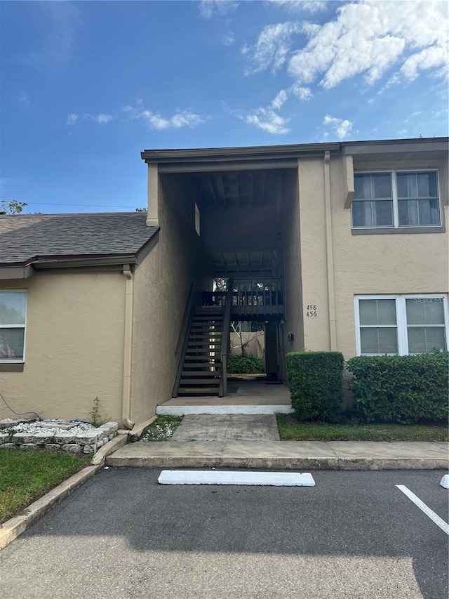 458 Windmeadows St, Altamonte Springs, FL 32701 - doorway to property with stucco siding, uncovered parking, and a shingled roof