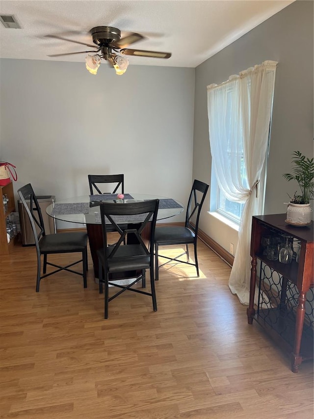 dining room featuring ceiling fan and light hardwood / wood-style flooring