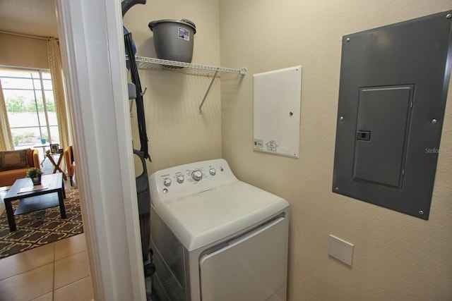 clothes washing area featuring washer / dryer, electric panel, and tile patterned flooring