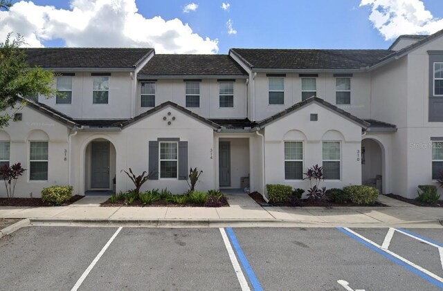 314 Captiva Dr, Davenport, FL 33896 - townhome / multi-family property featuring uncovered parking and stucco siding