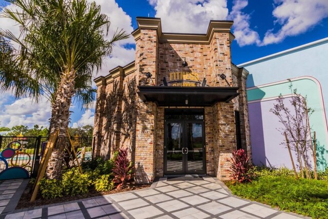 314 Captiva Dr, Davenport, FL 33896 - property entrance featuring french doors and brick siding