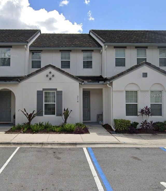 314 Captiva Dr, Davenport, FL 33896 - view of property with uncovered parking and stucco siding